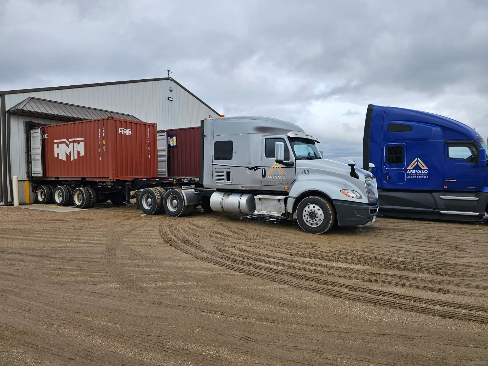 Arevalo truck with a container at a customer dock