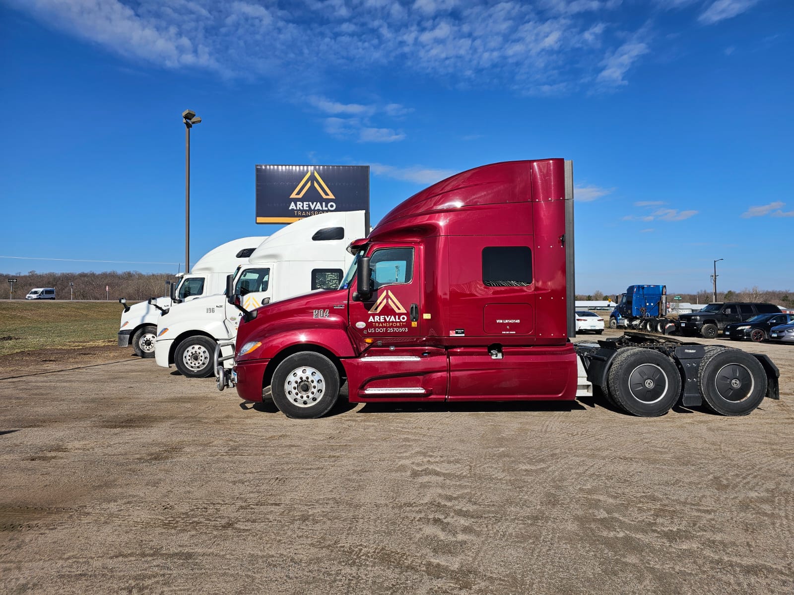 Reliable red and white truck at Arevalo Transport's shop in Minnesota. Arevalo Transport, a leading trucking company in Minnesota, proudly displays one of its red and white trucks at our state-of-the-art shop. As a top truck company, we ensure our fleet is always in peak condition to provide exceptional transportation services across the state and beyond. Trust Arevalo Transport for all your freight needs, backed by our commitment to quality and reliability.