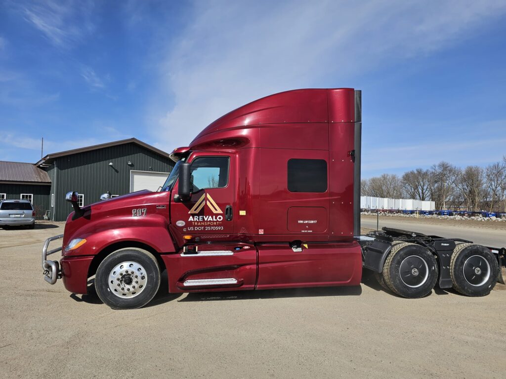 To visually represent the fleet and services of Arevalo Transport, a leading trucking company in Minnesota, through a striking image of a red truck.